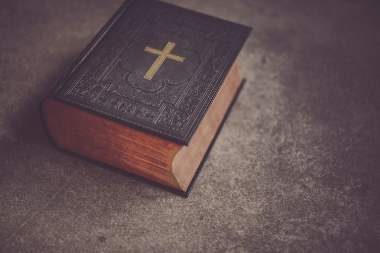 black Bible on gray surface